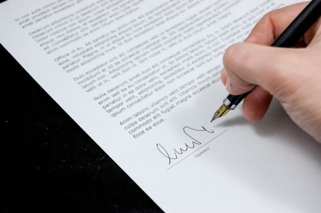 a person signing an example document